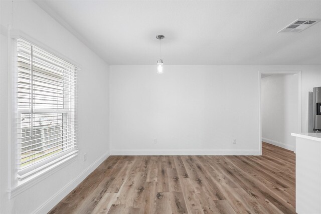 1720 Bagby Ave, Waco, TX 76706 - unfurnished dining area featuring healthy amount of natural light, light wood-style floors, and baseboards