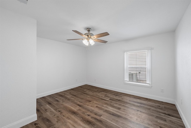 1720 Bagby Ave, Waco, TX 76706 - unfurnished room featuring a ceiling fan, dark wood-style floors, and baseboards