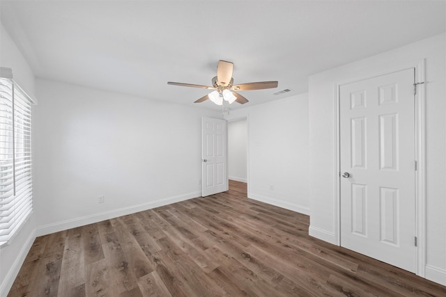 1720 Bagby Ave, Waco, TX 76706 - unfurnished bedroom featuring wood finished floors, baseboards, and a ceiling fan