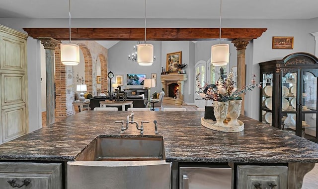 8416 Spicewood Springs Rd, Waco, TX 76633 - bar with a sink, lofted ceiling, a lit fireplace, and decorative light fixtures
