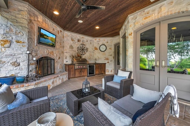 8416 Spicewood Springs Rd, Waco, TX 76633 - living area with wood ceiling, stone tile flooring, wine cooler, ornamental molding, and ceiling fan