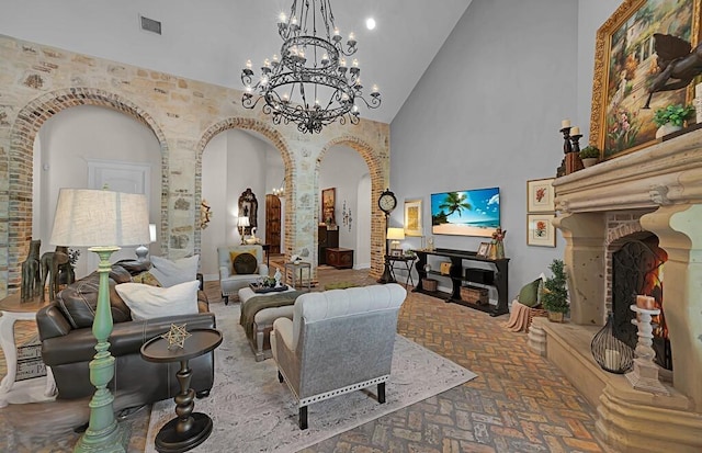 8416 Spicewood Springs Rd, Waco, TX 76633 - living area featuring arched walkways, high vaulted ceiling, brick floors, a chandelier, and decorative columns