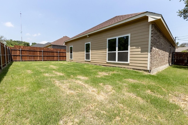 1435 Vine St, Weatherford, TX 76086 - rear view of property with a fenced backyard and brick siding