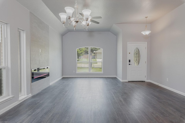 1435 Vine St, Weatherford, TX 76086 - entrance foyer with dark wood finished floors, a ceiling fan, a fireplace, a chandelier, and lofted ceiling