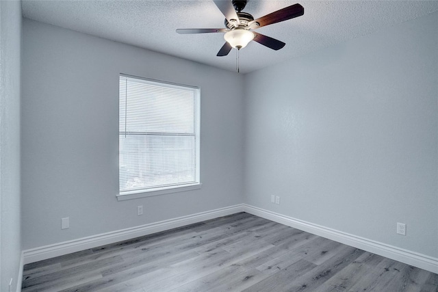 1410 W Torrey St, Granbury, TX 76048 - unfurnished room featuring wood finished floors, plenty of natural light, a textured ceiling, a ceiling fan, and baseboards