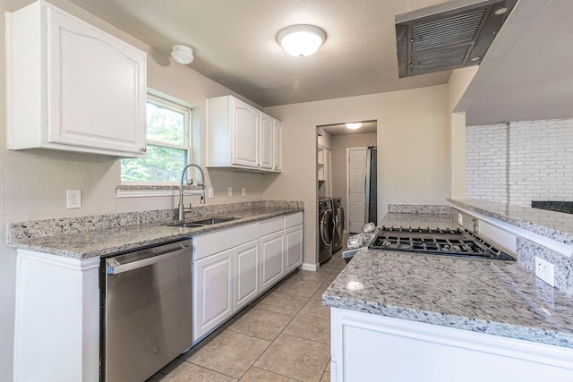 2218 Archer Trl, Denton, TX 76209 - kitchen featuring appliances with stainless steel finishes, a sink, separate washer and dryer, and white cabinetry
