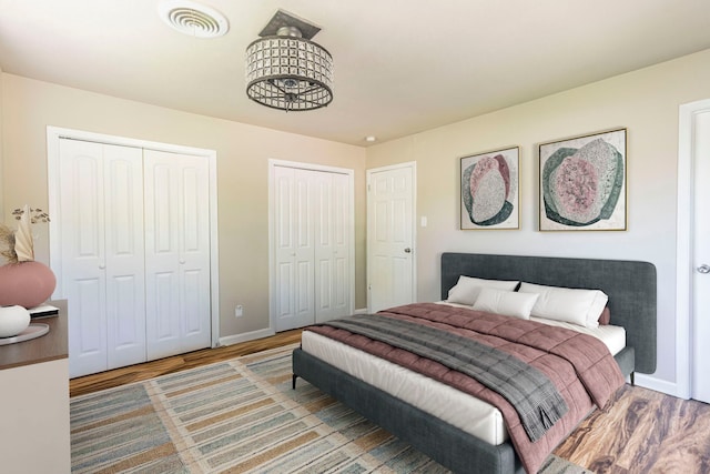 2218 Archer Trl, Denton, TX 76209 - bedroom with multiple closets, wood finished floors, and baseboards