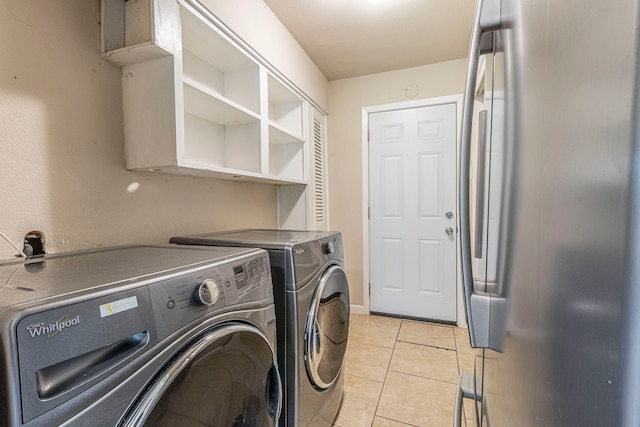 2218 Archer Trl, Denton, TX 76209 - laundry room with washer and dryer and light tile patterned flooring