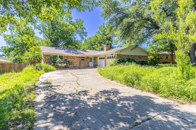 2218 Archer Trl, Denton, TX 76209 - single story home with brick siding, concrete driveway, a chimney, an attached garage, and fence