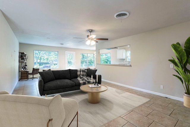 2218 Archer Trl, Denton, TX 76209 - living area with healthy amount of natural light, ceiling fan, baseboards, and light tile patterned flooring