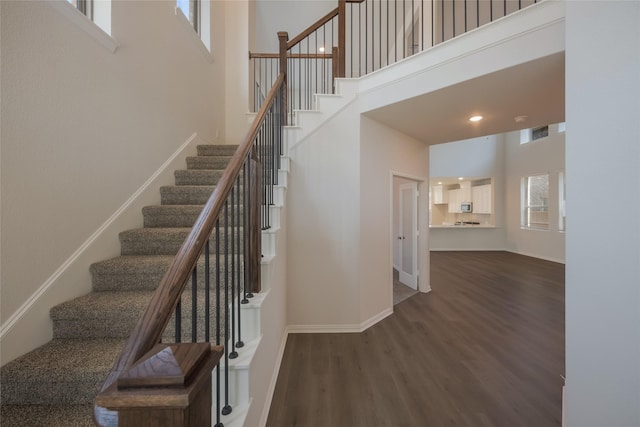 4118 Beale St, Heartland, TX 75114 - staircase featuring a high ceiling, wood finished floors, and baseboards