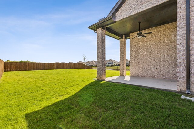 view of yard with ceiling fan and a patio area