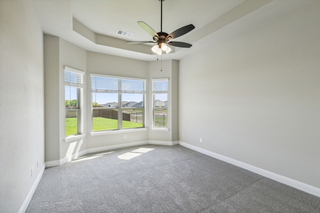 unfurnished room featuring carpet floors, baseboards, and ceiling fan