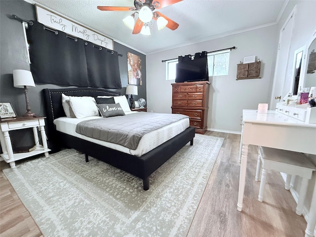 108 Martha Dr, Winnsboro, TX 75494 - bedroom with wood finished floors, crown molding, a ceiling fan, and baseboards