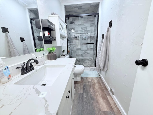 108 Martha Dr, Winnsboro, TX 75494 - full bathroom with wood finished floors, a stall shower, vanity, and toilet