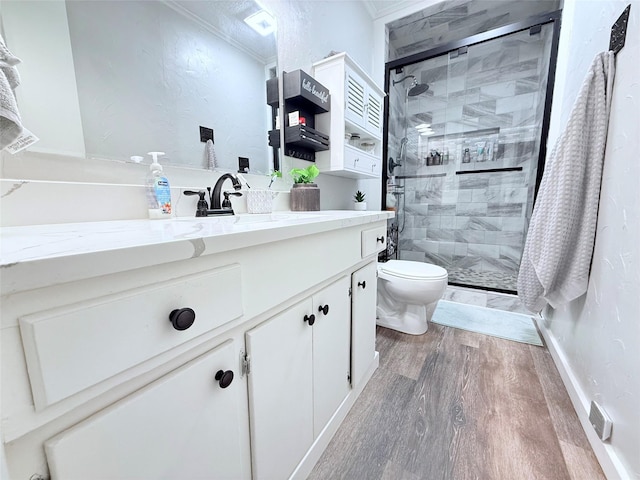 108 Martha Dr, Winnsboro, TX 75494 - bathroom with wood finished floors, toilet, a shower stall, ornamental molding, and vanity