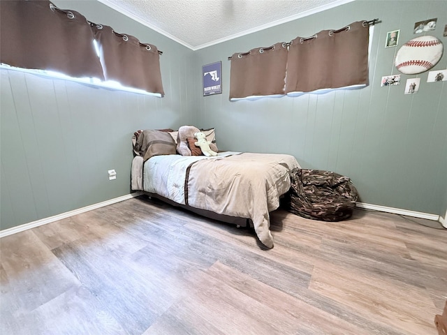 108 Martha Dr, Winnsboro, TX 75494 - bedroom featuring ornamental molding, a textured ceiling, wood finished floors, and baseboards