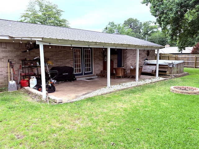 108 Martha Dr, Winnsboro, TX 75494 - rear view of house featuring a hot tub, a patio area, and brick siding
