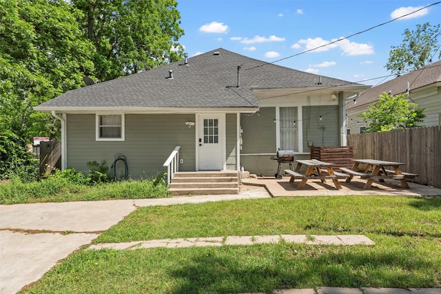 3801 Homan Ave, Waco, TX 76707 - rear view of house featuring roof with shingles, a patio, and entry steps
