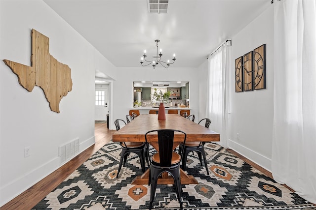 3801 Homan Ave, Waco, TX 76707 - dining room with a chandelier, wood finished floors, and baseboards