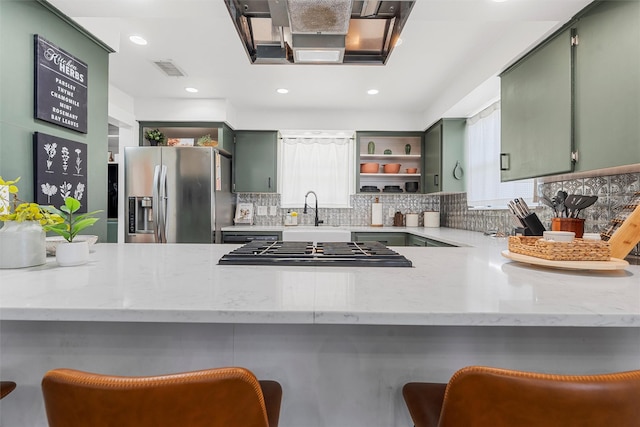 3801 Homan Ave, Waco, TX 76707 - kitchen with green cabinets, appliances with stainless steel finishes, a sink, open shelves, and decorative backsplash
