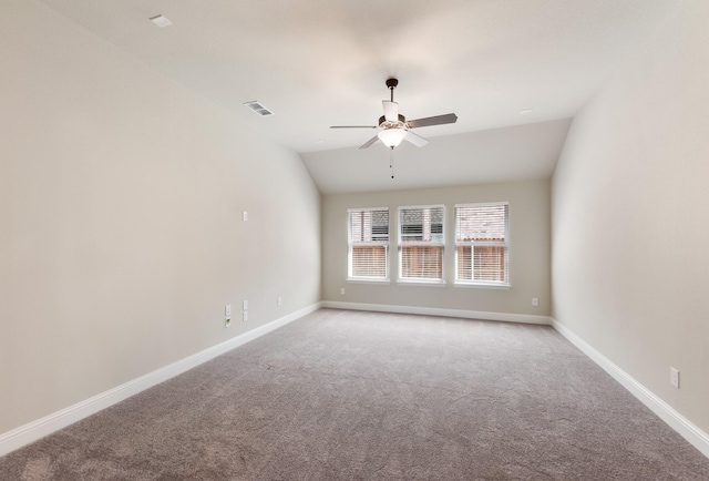 empty room featuring light colored carpet, ceiling fan, baseboards, and vaulted ceiling