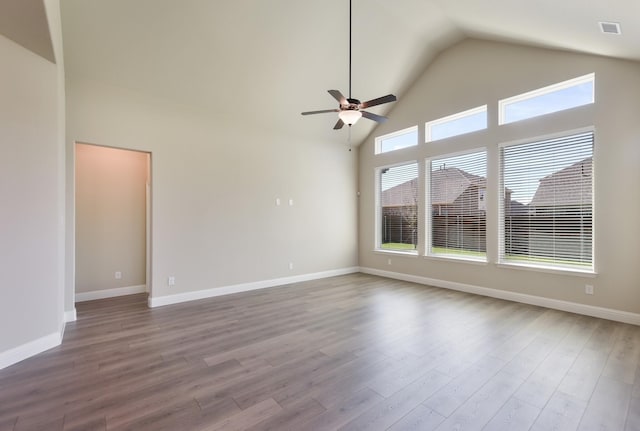 unfurnished living room featuring a ceiling fan, wood finished floors, baseboards, and high vaulted ceiling