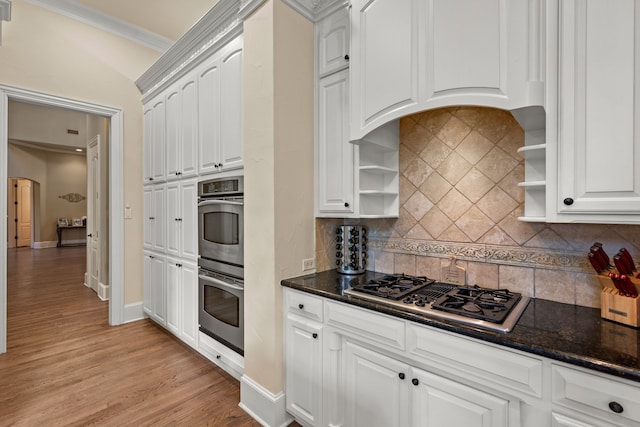kitchen featuring open shelves, stainless steel double oven, stovetop with downdraft, white cabinetry, and dark stone counters