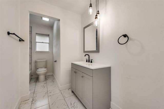 4900 S Drive, Fort Worth, TX 76132 - bathroom featuring baseboards, marble look tiles, vanity, and toilet
