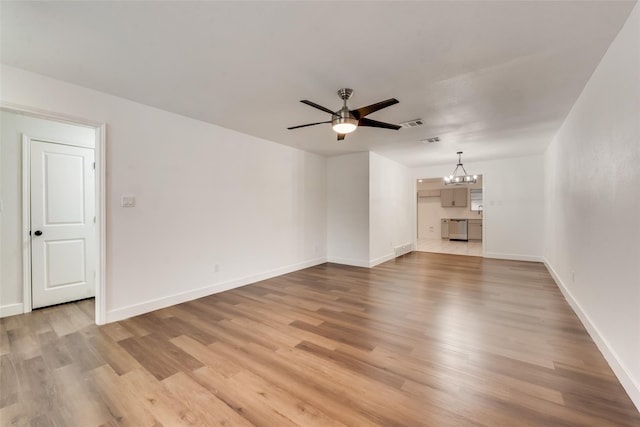 4900 S Drive, Fort Worth, TX 76132 - unfurnished living room featuring a chandelier, light wood-style floors, a ceiling fan, and baseboards