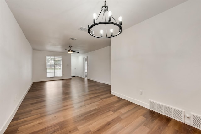 4900 S Drive, Fort Worth, TX 76132 - spare room featuring a chandelier, wood finished floors, a ceiling fan, and baseboards