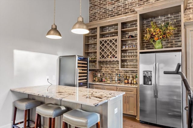 10031 Tumbling Trl, Waco, TX 76657 - kitchen featuring stainless steel fridge, open shelves, a sink, a breakfast bar, and light stone countertops