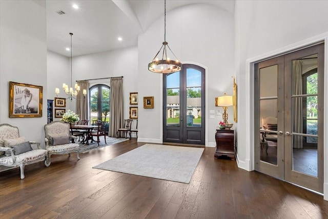 10031 Tumbling Trl, Waco, TX 76657 - entrance foyer with french doors, a chandelier, a high ceiling, dark wood-style flooring, and recessed lighting