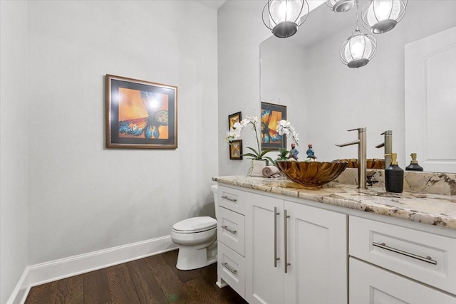 10031 Tumbling Trl, Waco, TX 76657 - bathroom featuring wood finished floors, baseboards, toilet, and vanity