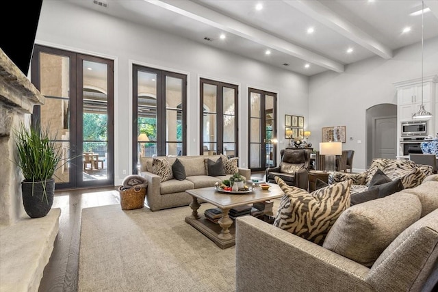 10031 Tumbling Trl, Waco, TX 76657 - living area featuring french doors, beamed ceiling, arched walkways, a towering ceiling, and recessed lighting