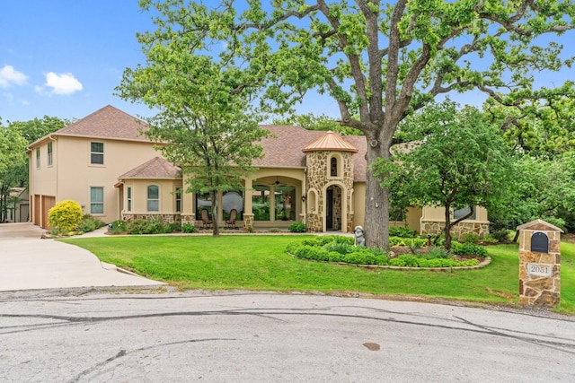 2051 E Oak Shores Dr, Cross Roads, TX 76227 - mediterranean / spanish-style house featuring stone siding, stucco siding, concrete driveway, and a front lawn