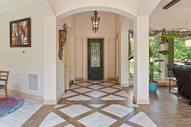 2051 E Oak Shores Dr, Cross Roads, TX 76227 - entrance foyer with arched walkways, inlaid floor details, baseboards, and a chandelier
