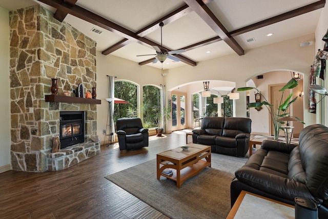 2051 E Oak Shores Dr, Cross Roads, TX 76227 - living area featuring ceiling fan, arched walkways, beamed ceiling, wood finished floors, and a fireplace