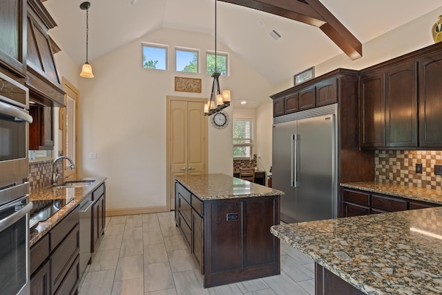 2051 E Oak Shores Dr, Cross Roads, TX 76227 - kitchen with appliances with stainless steel finishes, vaulted ceiling, dark stone counters, a kitchen island, and decorative backsplash