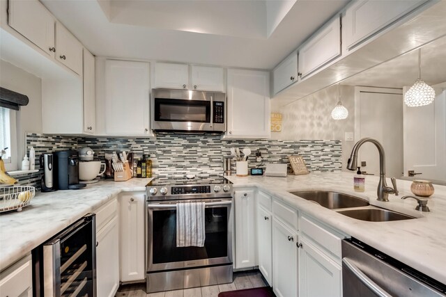 3201 Elizabeth St, Dallas, TX 75204 - kitchen with stainless steel appliances, a sink, beverage cooler, and backsplash