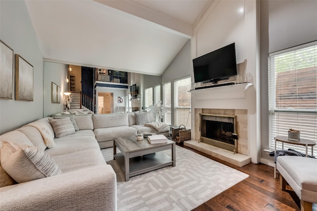 3201 Elizabeth St, Dallas, TX 75204 - living area with a fireplace, wood finished floors, high vaulted ceiling, stairs, and plenty of natural light