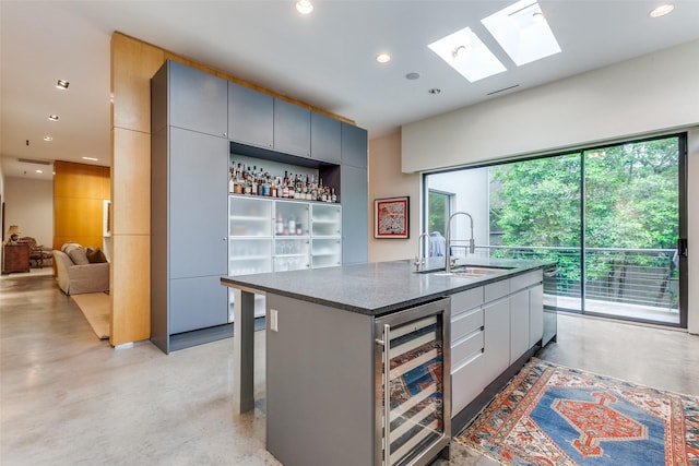 4335 Travis St, Dallas, TX 75205 - kitchen with beverage cooler, finished concrete flooring, a sink, recessed lighting, and dark stone counters