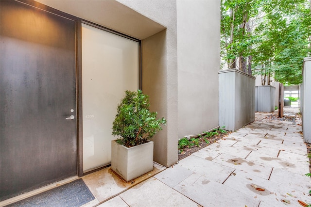 4335 Travis St, Dallas, TX 75205 - entrance to property featuring stucco siding, a patio, and fence