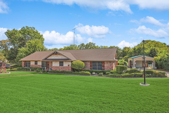 view of front facade featuring a front yard, a garage, and brick siding