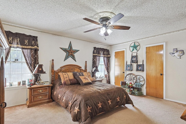 carpeted bedroom with a textured ceiling, ceiling fan, and baseboards