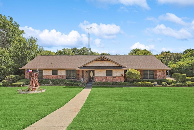 ranch-style house featuring a front yard, brick siding, and a shingled roof