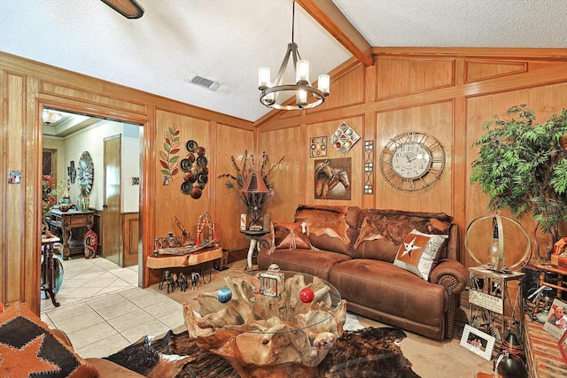 living area featuring vaulted ceiling, a chandelier, tile patterned flooring, wooden walls, and a textured ceiling