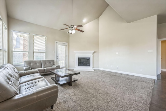 301 Harcourt Ave, Mckinney, TX 75072 - living area with ceiling fan, baseboards, a glass covered fireplace, dark wood-style flooring, and high vaulted ceiling