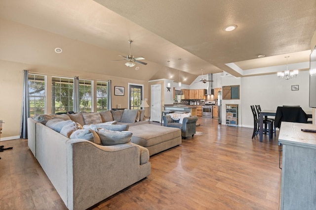 11240 County Road 102, Grandview, TX 76050 - living room featuring ceiling fan, a chandelier, light wood-style floors, baseboards, and lofted ceiling