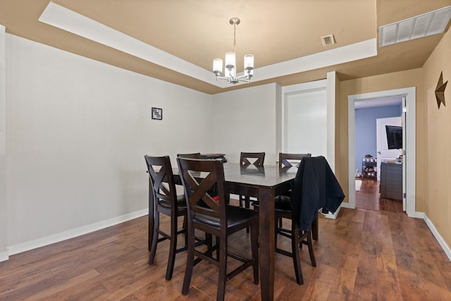 11240 County Road 102, Grandview, TX 76050 - dining area featuring a raised ceiling, a chandelier, baseboards, and wood finished floors